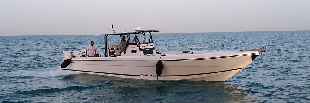 Doha Craft Cobia center console boat running at sea with fenders out